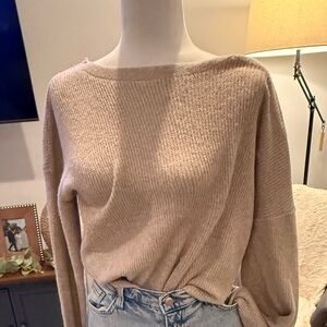 Stylish tan sweater with tie bow back.